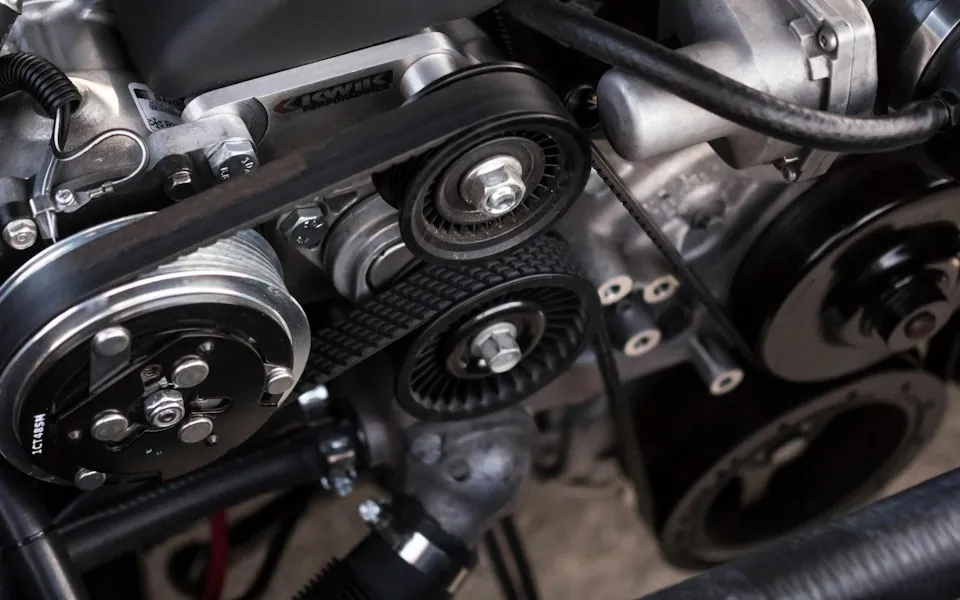 Engine components and belts in an automotive workshop